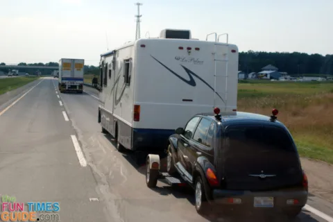 Motorhome towing a car on a dolly