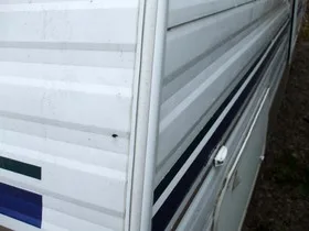 The rear corner of a fifth wheel travel trailer.