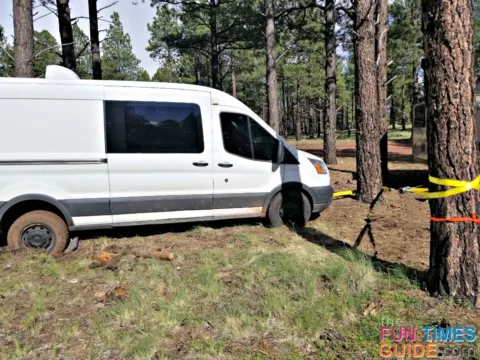 Using a come along to get RV van unstuck in the mud.